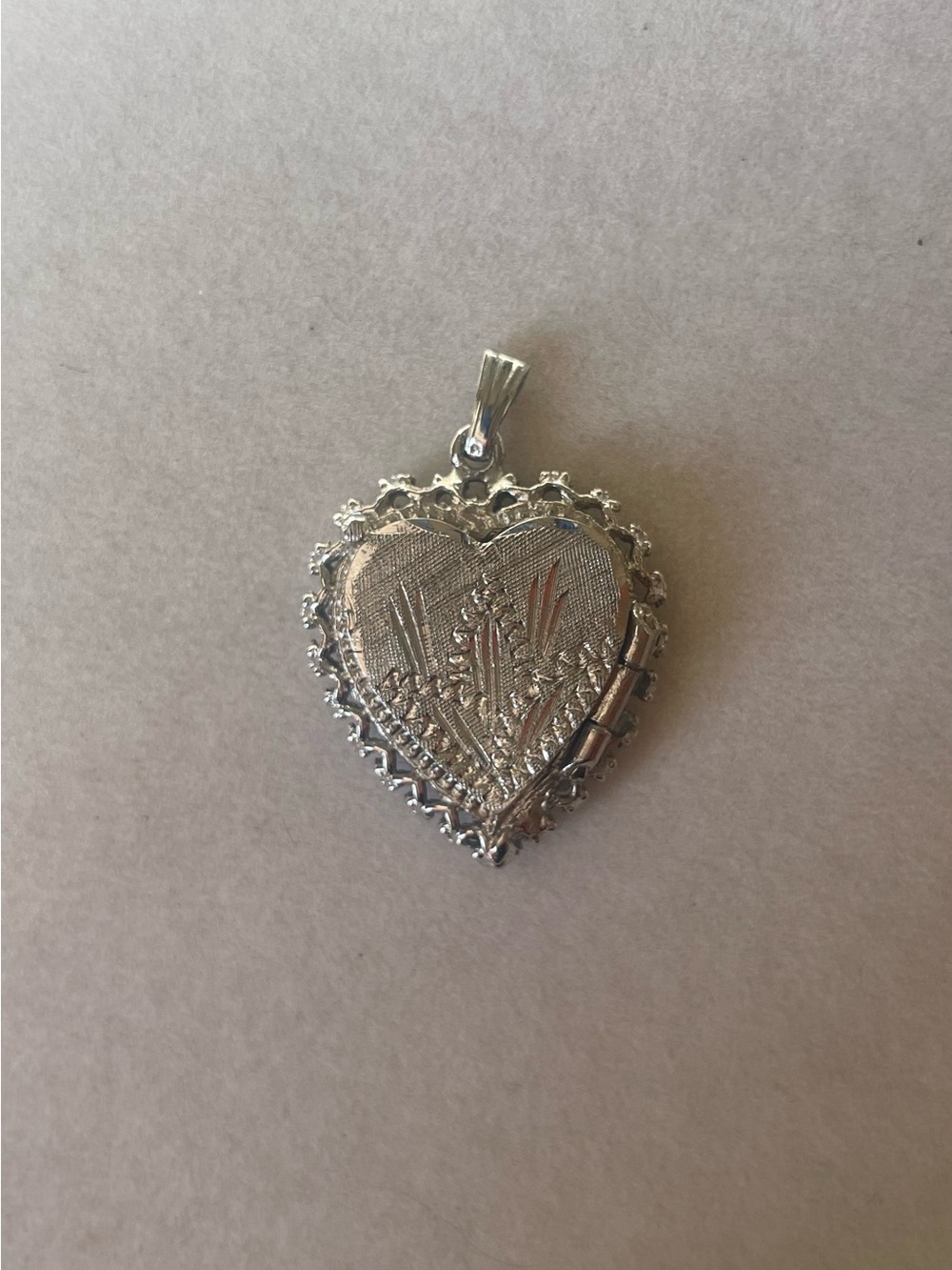Heart-Shaped Floral Locket Pendant in sterling.